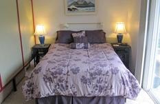Cozy bedroom with soft pillows and ocean light