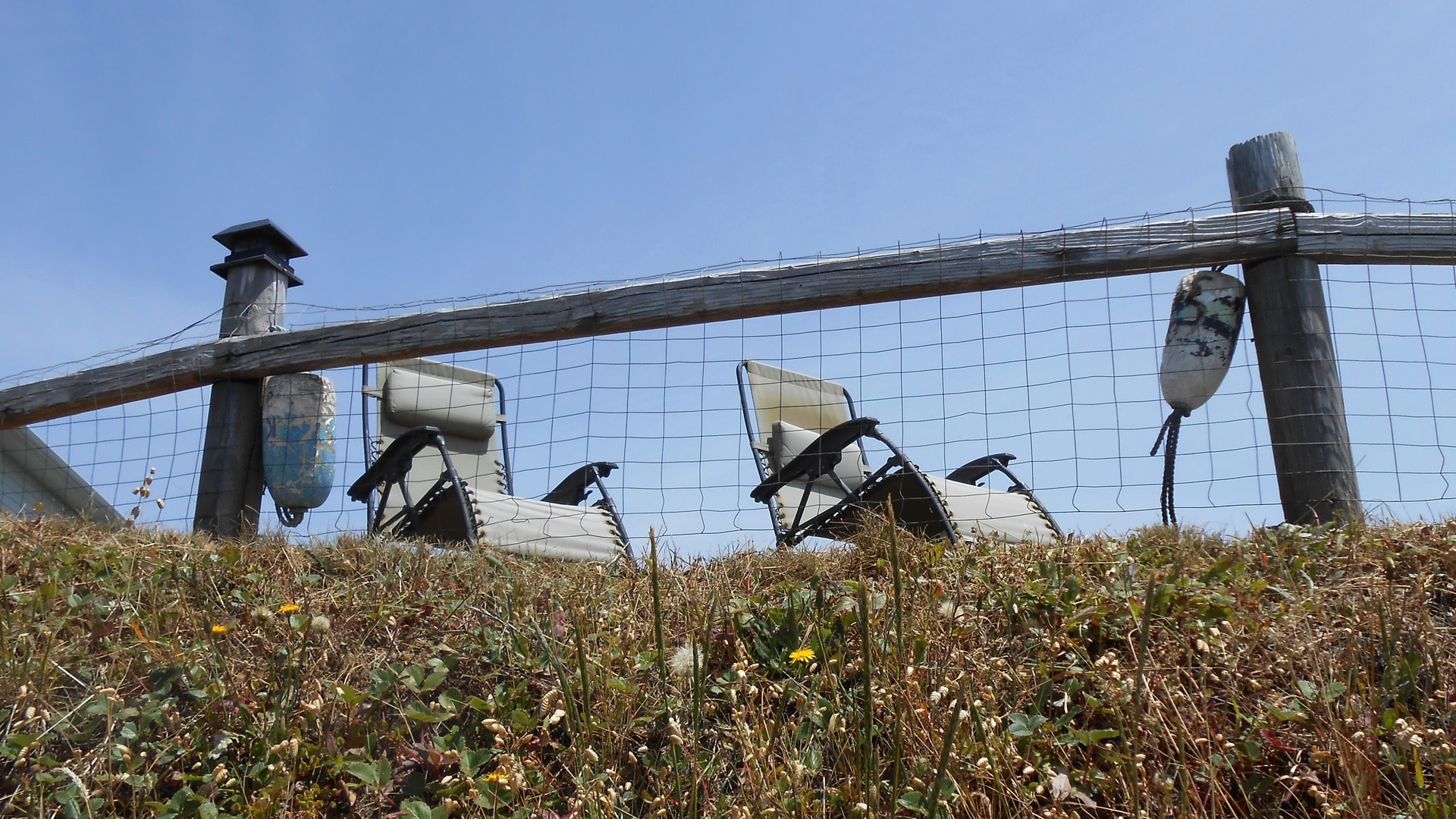 Beach chairs and volleyball net at Sea Escape