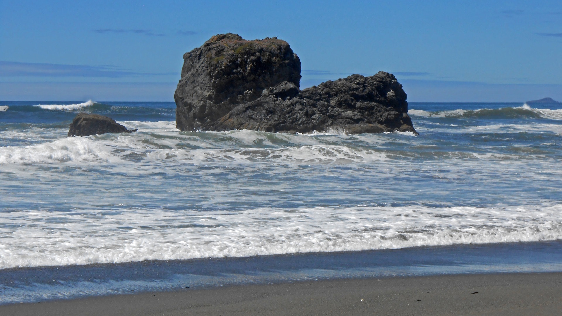 Rocky sea stack with waves on the Northern California coast